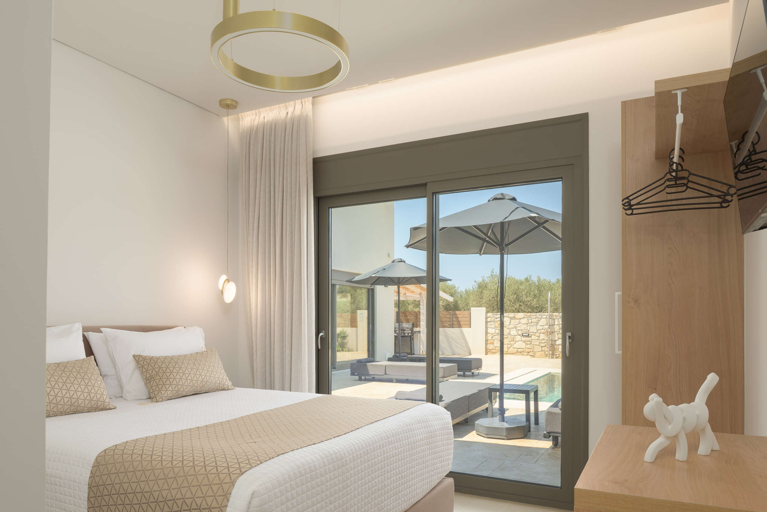 Bright queen bedroom with direct pool access and premium furnishings.